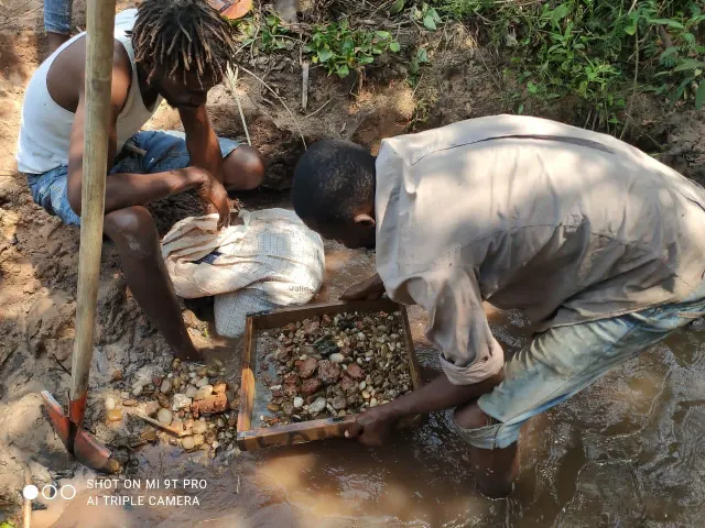 Sifting gravel at an alluvial site