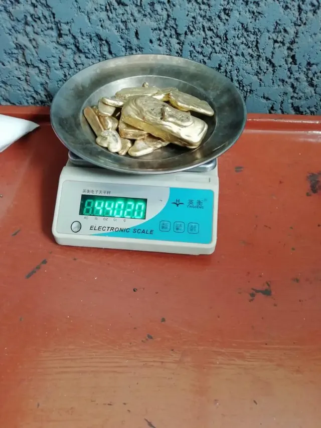 Gold pieces being weighed